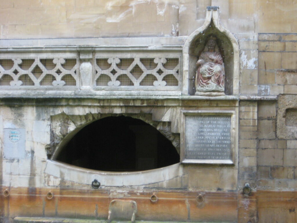 Stonework and statuary at one end of the Roman bath in Bath, England
